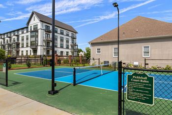 A pickleball court with a sign
